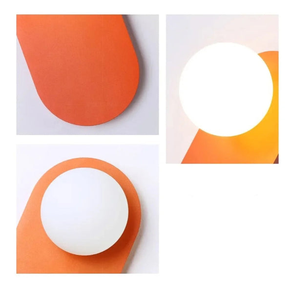 Lampe murale en forme de boule de verre sur une plaque